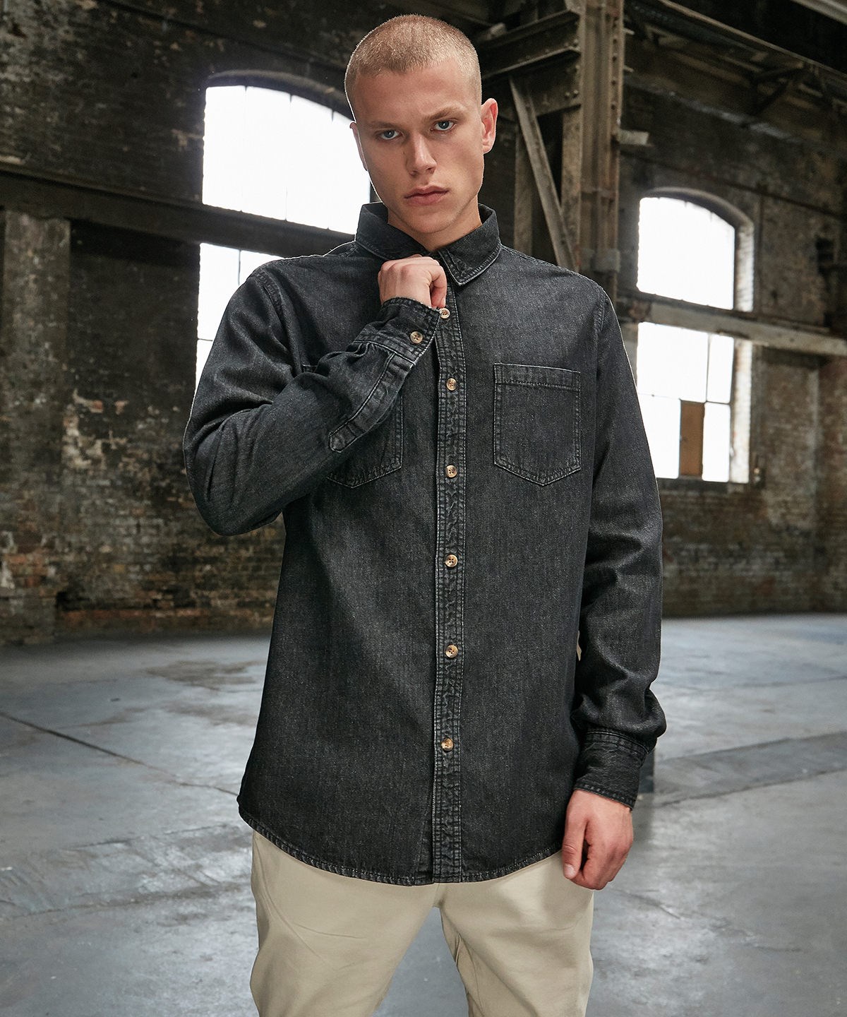 Detail of black denim clothing in an industrial building