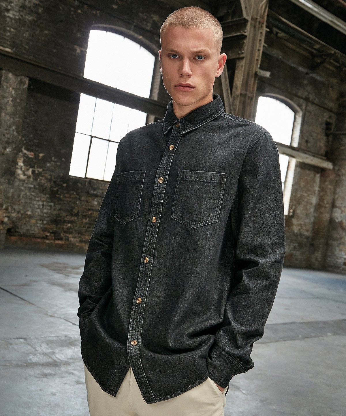 Black denim shirt worn in an industrial setting